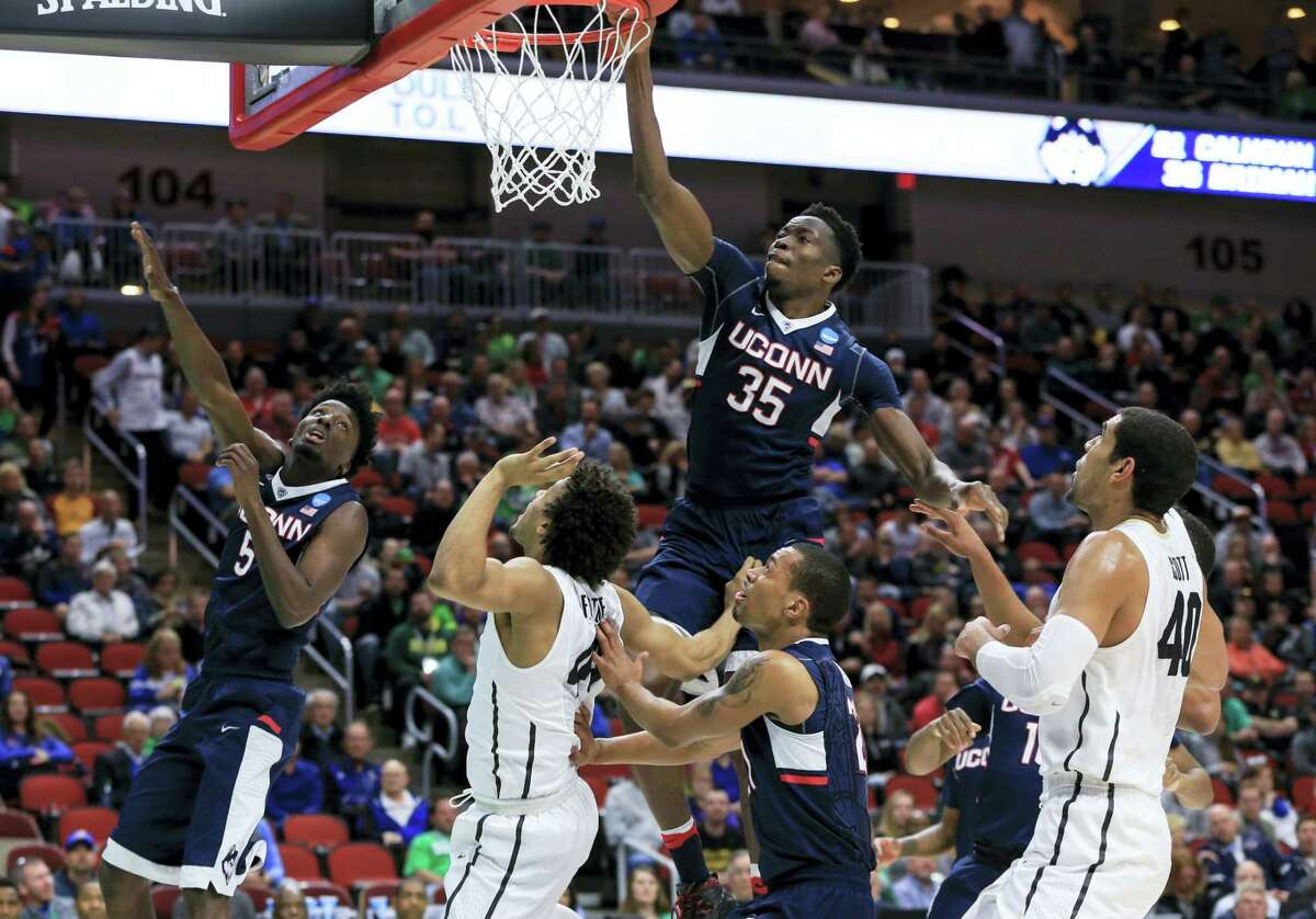 UConn’s Amida Brimah, center, will be joining Daniel Hamilton in testing the NBA draft waters.