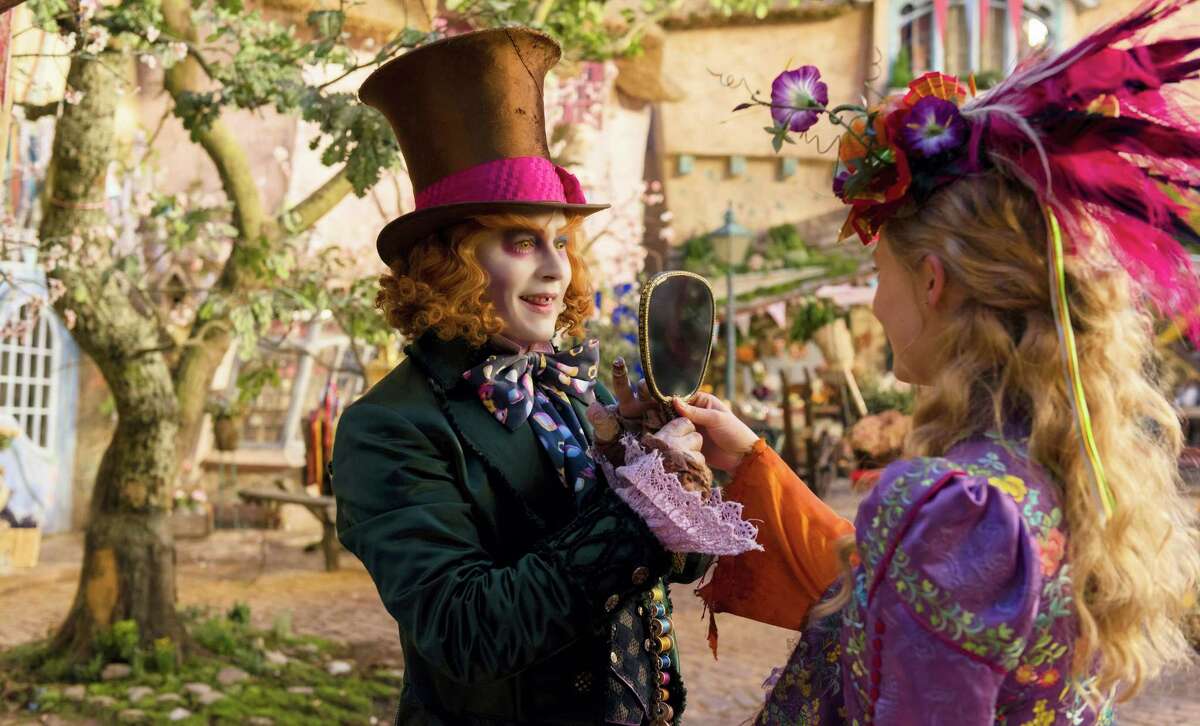 FILE - In this image released by Disney, Johnny Depp, left, and Mia Wasikowska appear in a scene from "Alice Through The Looking Glass."