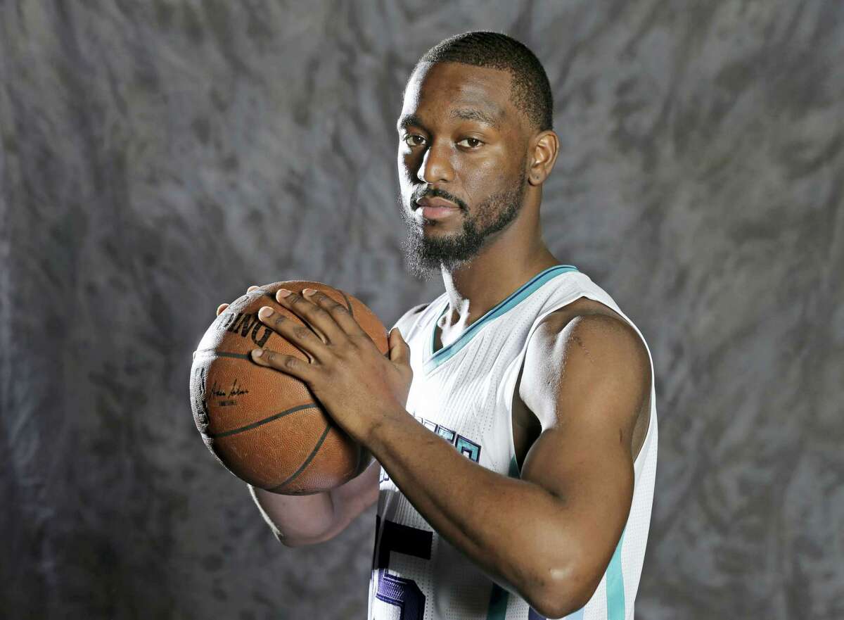 In this photo taken Sept. 26, 2016, Charlotte Hornets' Kemba Walker poses for a photo during the NBA basketball team's media day in Charlotte, N.C. Walker has been on the verge of becoming an NBA All-Star. Nicolas Batum and other teammates believe this will be the year the sixth-year pro finally breaks through. (AP Photo/Chuck Burton)
