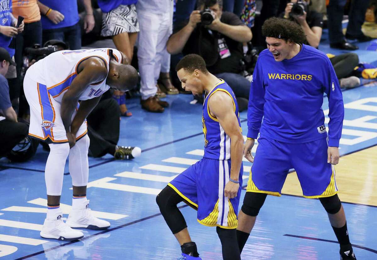 Stephen Curry, left, and Anderson Varejao (18) celebrate as Thunder forward Serge Ibaka reacts during the second half of Game 6 on Saturday. The Warriors won 108-101.