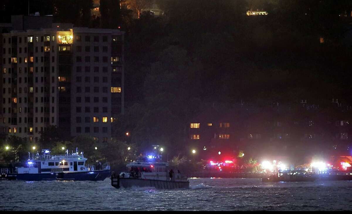In this photo taken from video, search and rescue boats look for a small plane that went down in the Hudson River, Friday, May 27, 2016, near West New York, N.J. The Federal Aviation Administration says it received a report a World War II vintage P-47 Thunderbolt aircraft may have gone down in the river 2 miles south of the George Washington Bridge.
