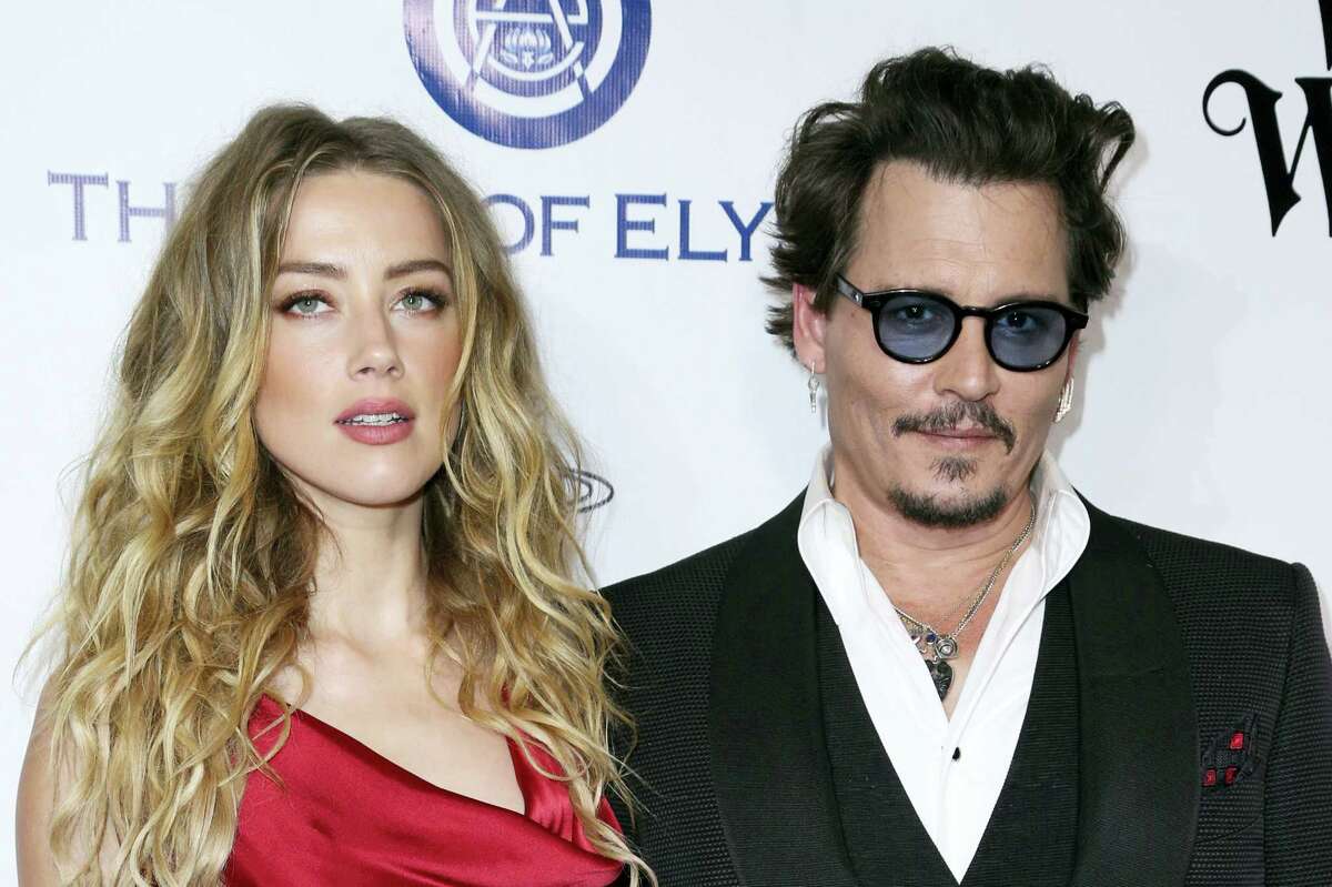 In this Jan. 9, 2016 file photo, Amber Heard, left, and Johnny Depp arrive at The Art of Elysium’s Ninth annual Heaven Gala at 3LABS, in Culver City, Calif. Heard was in Los Angeles Superior Court court on Friday, May 27, 2016, and provided a sworn declaration that her husband Johnny Depp threw her cellphone at her during a fight Saturday, striking her cheek and eye. The judge ordered Depp to stay away from his estranged wife and ruled that Depp shouldn’t try to contact Heard until a hearing is conducted on June 17. Heard filed for divorce on Monday.