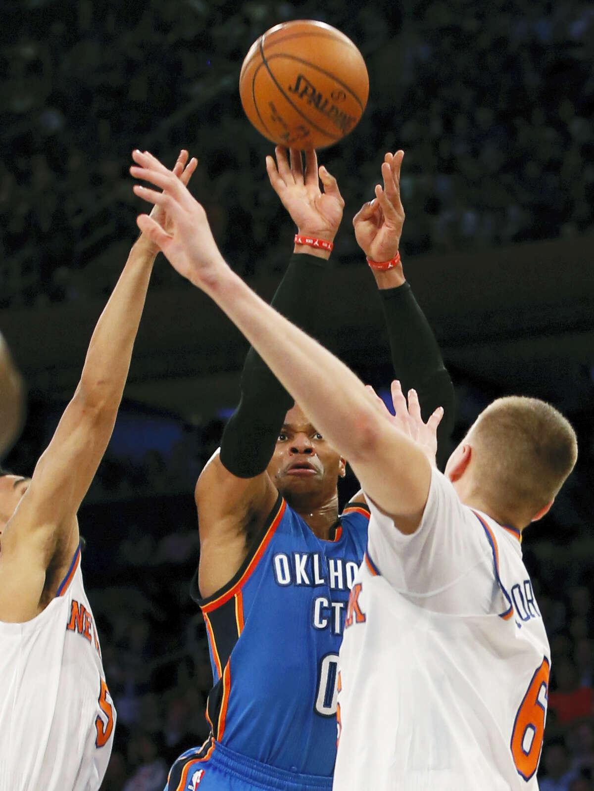 Thunder guard Russell Westbrook shoots between a pair of Knicks defenders on Monday.