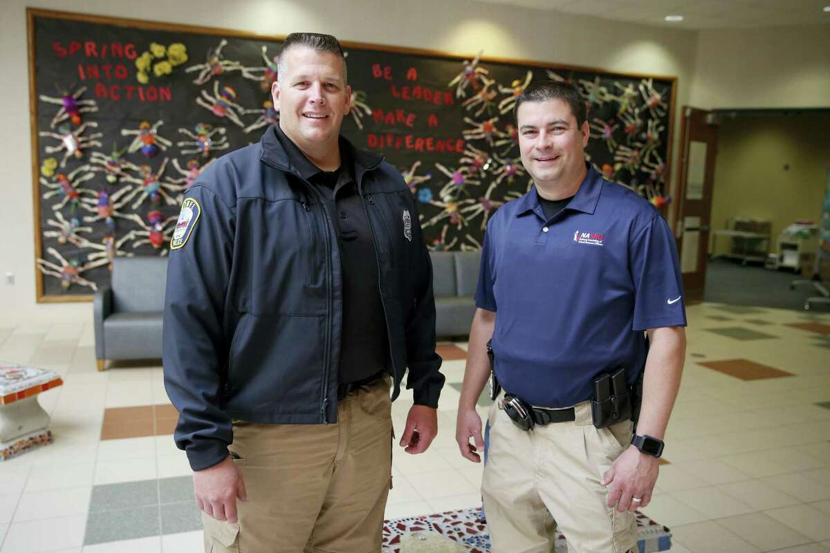 AP Photo/Michael Conroy In this photo taken May 6, 2016, Carmel, Ind. Police officers Greg DeWald, left, and D.J. Schoeff pose the the entrance to Forest Dale Elementary School in Carmel, Ind. More and more, schools these days are conducting active-shooter drills. A government report found that more than two-thirds of the school districts surveyed conduct active shooter exercises.