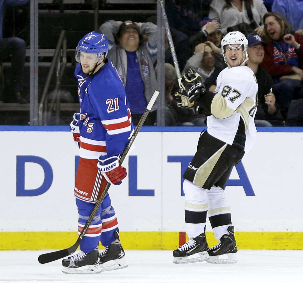 Pittsburgh Penguins’ Sidney Crosby, right, and New York Rangers’ Derek Stepan react after Crosby scored the game winning goal during the overtime period Sunday in New York. The Penguins defeated the Rangers 3-2.