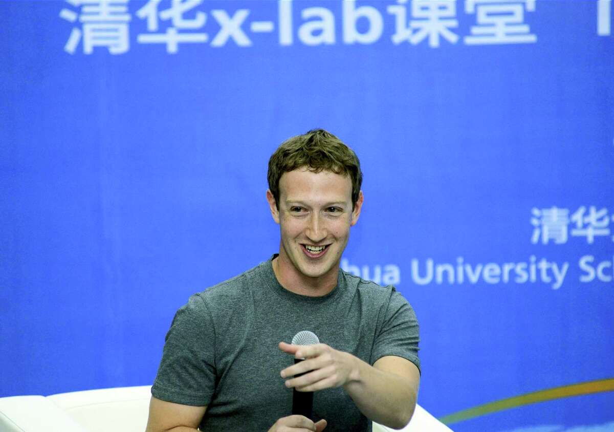 In this 2014 photo, Facebook co-founder Mark Zuckerberg speaks during a dialogue with students as a member to the advisory board for Tsinghua University School of Economics and Management in Beijing, China.