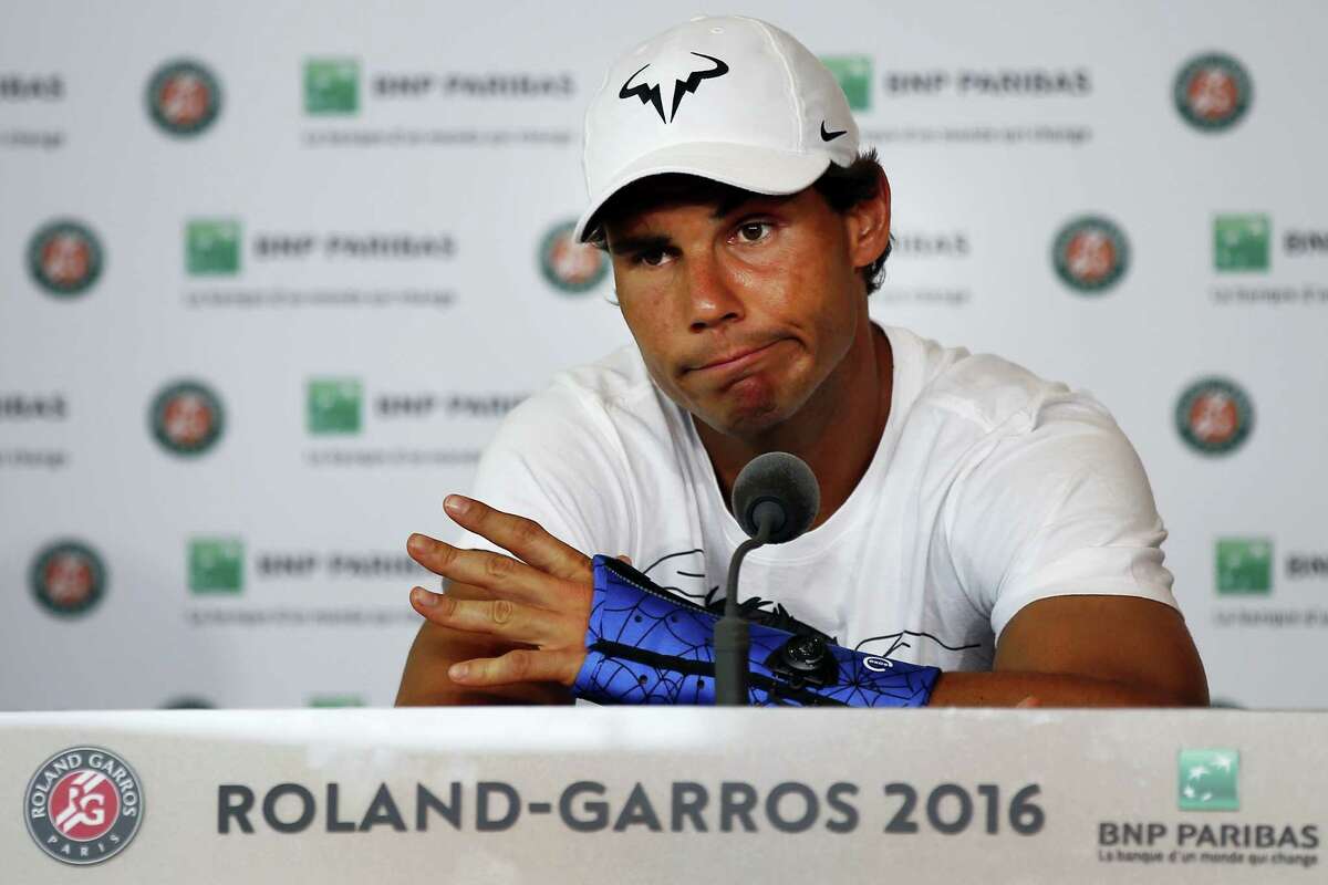 Nine-time champion Rafael Nadal announces he is pulling out of the French Open because of an injury to his left wrist during a press conference at the Roland Garros stadium in Paris, France, Friday May 27, 2016. The left-handed Nadal made the announcement at a hastily arranged news conference Friday, one day before he would have been scheduled to play his third-round match.