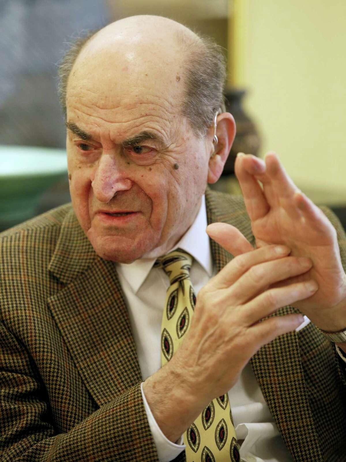 In this Feb. 5, 2014, file photo, Dr. Henry Heimlich describes the maneuver he developed to help clear obstructions from the windpipes of choking victims, while being interviewed at his home in Cincinnati. Heimlich recently used the emergency technique for the first time himself to save a woman choking on food at his senior living center. Heimlich said Thursday, May 26, 2016, that he has demonstrated the well-known maneuver many times through the years but had never before used it on a person who was choking.