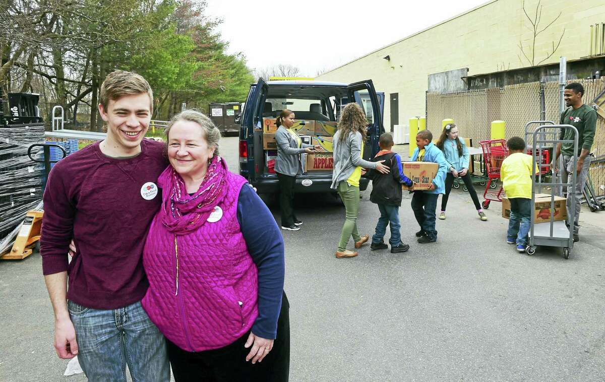 Caleb MartinMooney, 19, and his mother Lori Martin, both of New Haven, who represent Community Plates Greater New Haven, pick up food at Trader Joe’s food market in Orange recently with the assistance of ACES Mill Road School in North Haven. Community Plates directly transfers fresh, usable food that would have otherwise been thrown away from restaurants, markets and other food industry sources to food-insecure families, according to the organization’s website.
