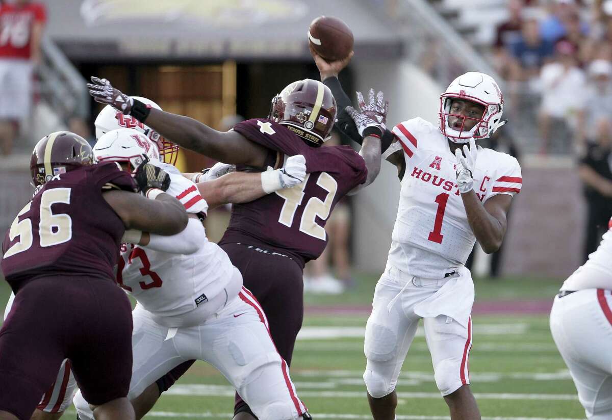 Houston quarterback Greg Ward, Jr., throws the ball over Texas State defenders during the first half of an NCAA college football game, Saturday, Sept. 24, 2016, in San Marcos, Texas. (AP Photo/Darren Abate)