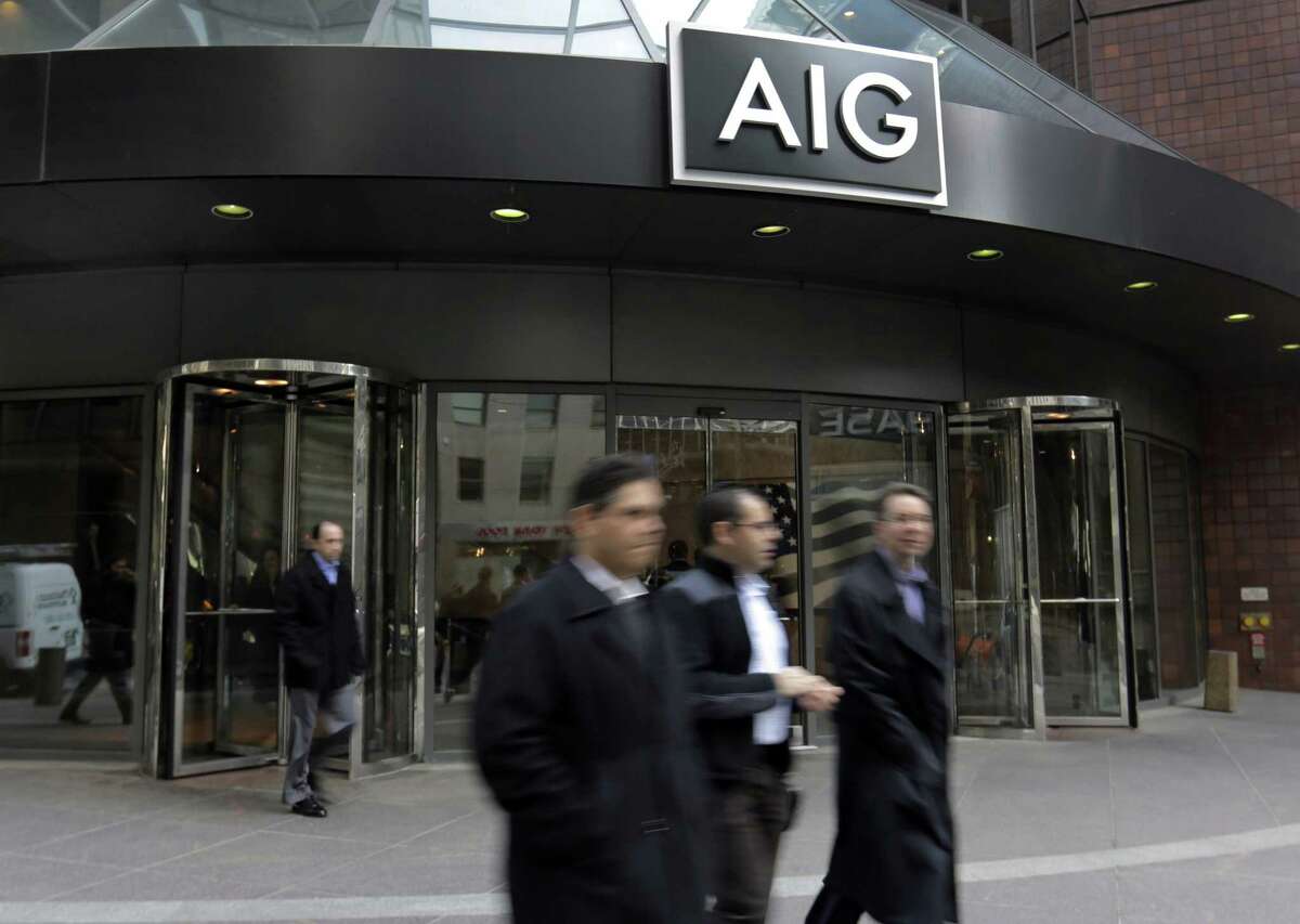 People pass the AIG building in New York.