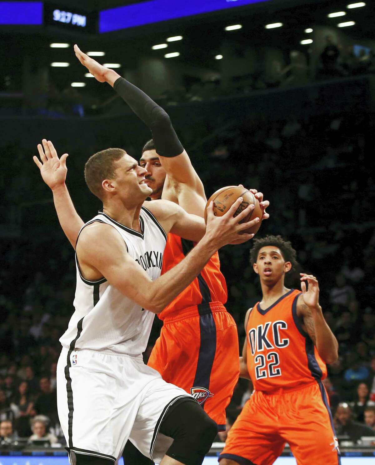 Brooklyn Nets center Brook Lopez (11) runs into Oklahoma City Thunder center Enes Kanter (11) as he goes up for a layup in the second half Sunday. Lopez finished with 31 points.