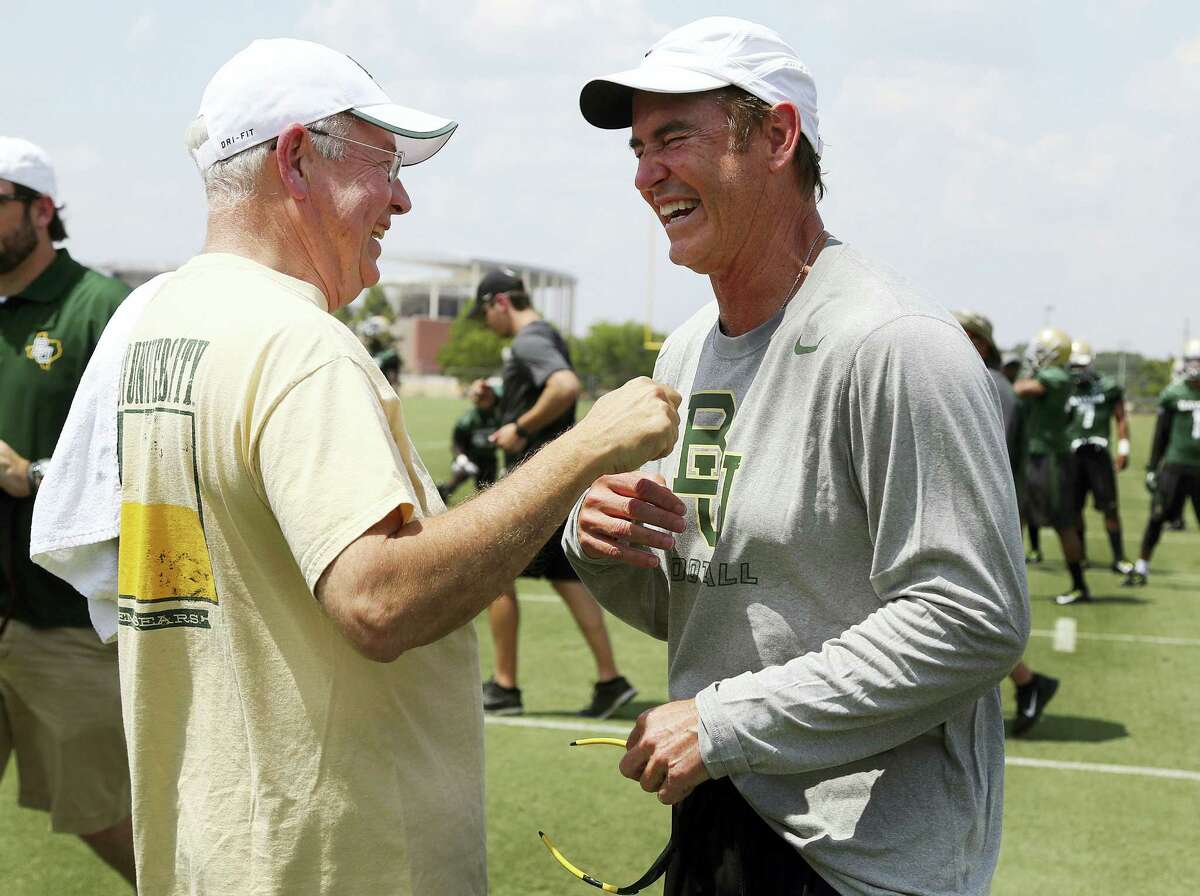 Rod Aydelotte/Waco Tribune-Herald via AP, File In this Aug. 5, 2014, file photo,Baylor University President Ken Starr, left, jokes with head football coach Art Briles, right, on the first day of NCAA college football practice in Waco, Texas. Baylor University’s board of regents says it will fire Briles and re-assign Starr in response to questions about its handling of sexual assault complaints against players. The university said in a statement Thursday, May 26, 2016, that it had suspended Briles “with intent to terminate.” Starr will leave the position of president on May 31, but the school says he will serve as chancellor.