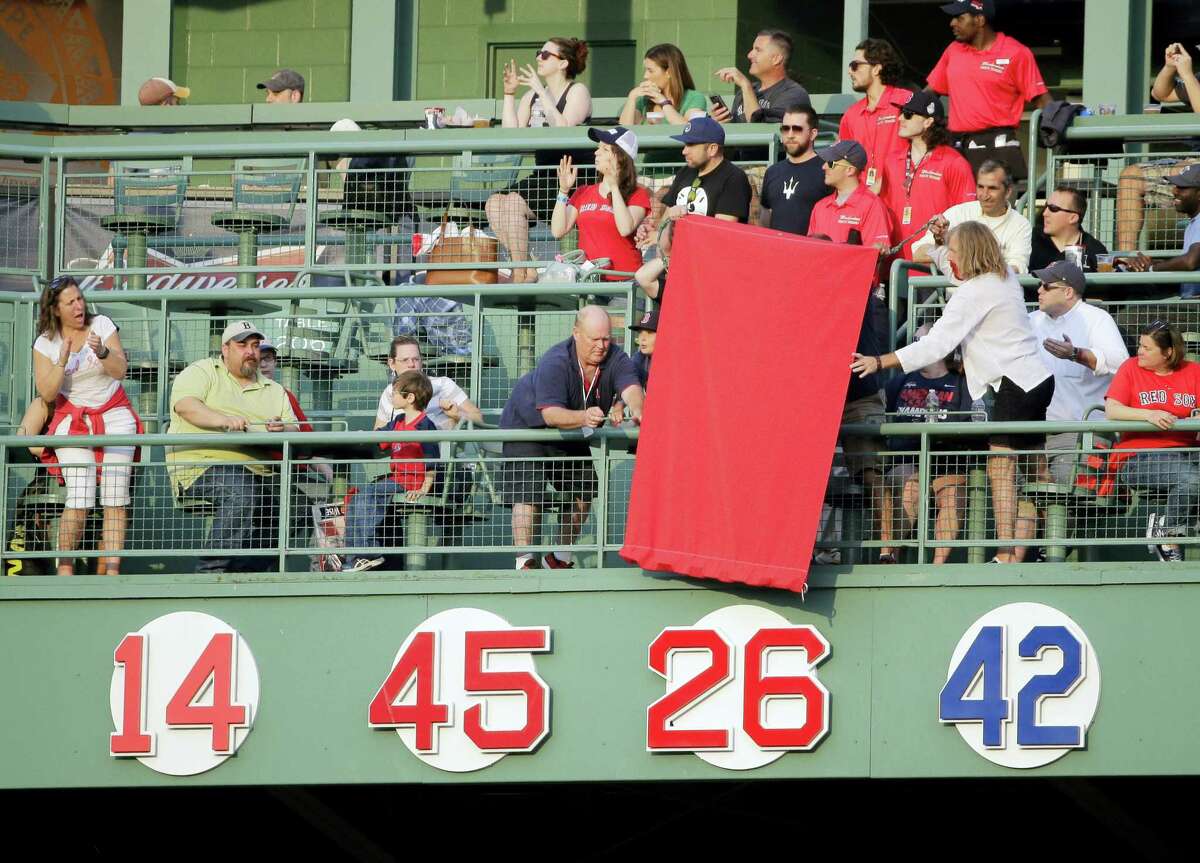 The No. 26 of former Red Sox player Wade Boggs is uncovered during the retirement ceremony on Thursday at Fenway Park.