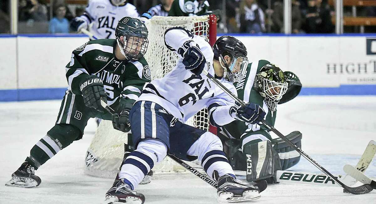 Yale’s Stu Wilson tries to sneak one past Dartmouth goalie Charles Grant during a game earlier this season.