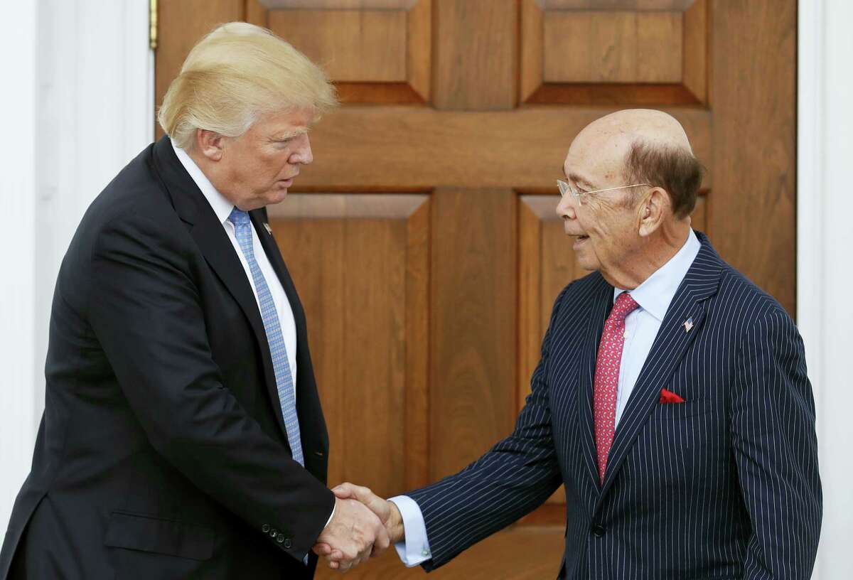 President-elect Donald Trump, left, shakes hands with investor Wilbur Ross after meeting at the Trump National Golf Club Bedminster clubhouse, Sunday, Nov. 20, 2016, in Bedminster, N.J.