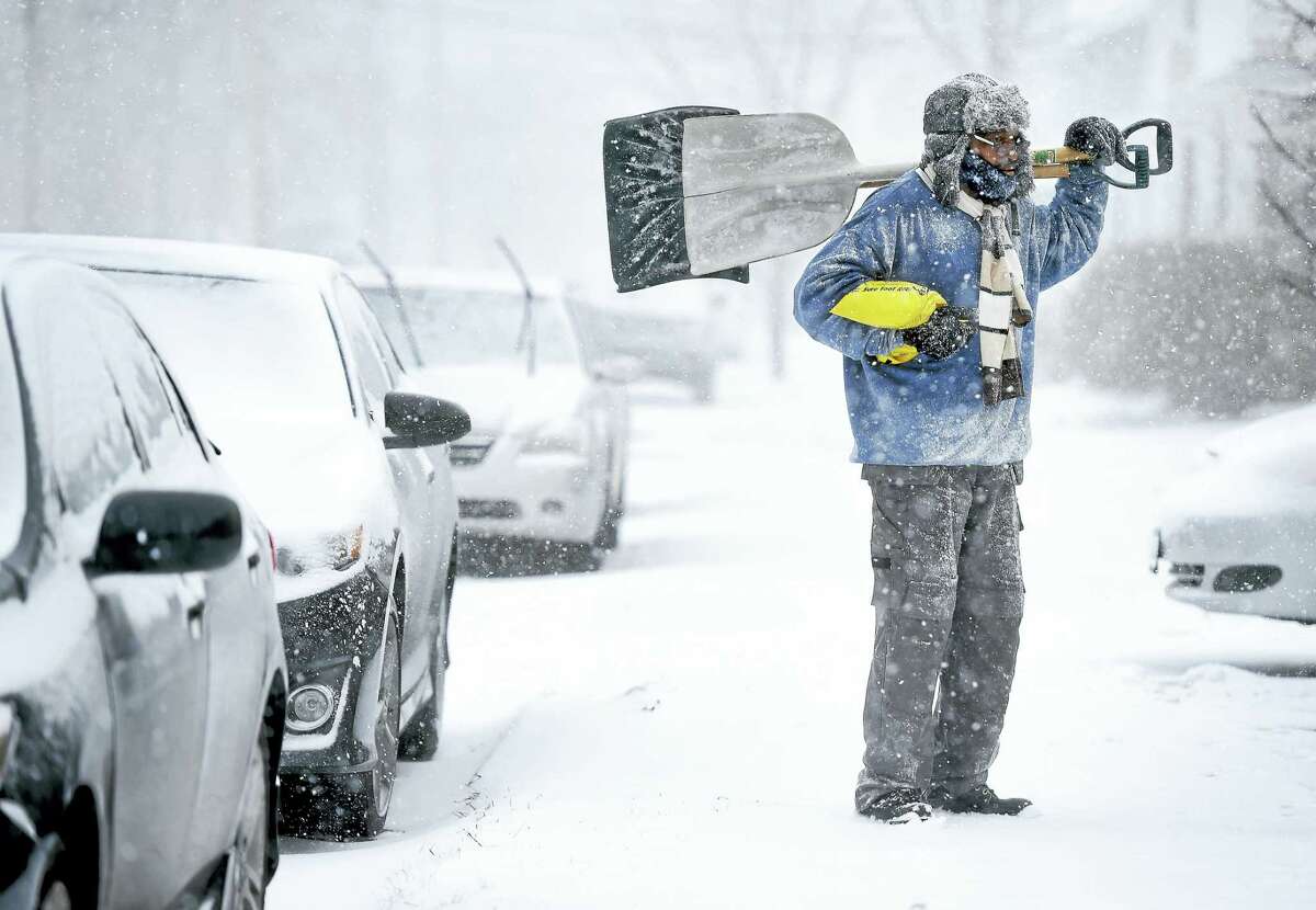 Jessie Frazier looks for shoveling customers with James Lamb (not in photo) in West Haven on 1/23/2016.