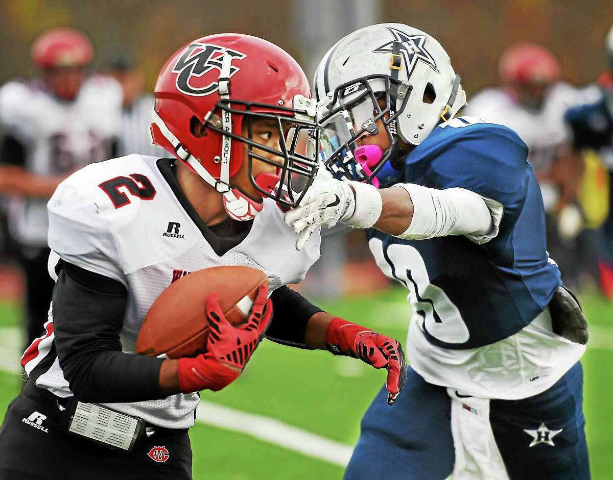 Wilbur Cross' Will Simmons looks for an opening as Hillhouse's Teron Mallory as the Academics defeat the Wilbur Cross Governors, 40-20, in the Elm City Bowl on Thanksgiving Day, November 26, 2015, at the newly renovated Bowen Field in New Haven. (Catherine Avalone/New Haven Register)