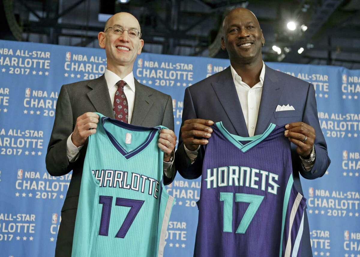 NBA commissioner Adam Silver, left, and Charlotte Hornets owner Michael Jordan, right, pose for a photo during a news conference to announce Charlotte, N.C., as the site of the 2017 NBA All-Star basketball game on June 23, 2015. The NBA has since decided to move the game in response to legislation regulating how transgender indiviuals use bathroom facilities in North Carolina.