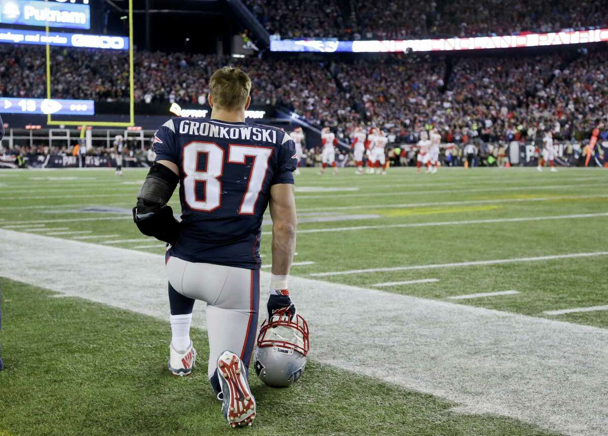 Patriots tight end Rob Gronkowski watches from the sidelines.