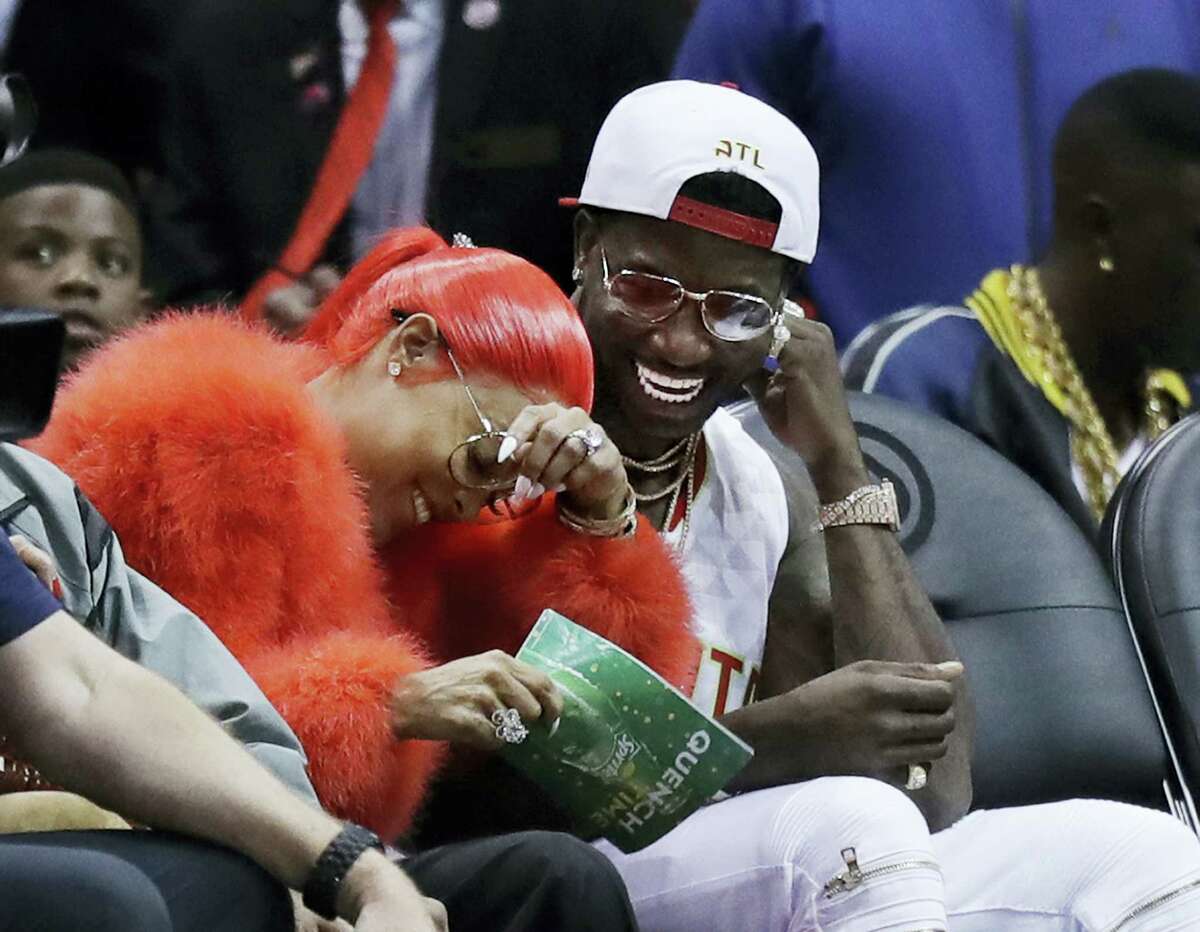 Hip Hop artist Gucci Mane, right, laughs with Keyshia Ka’oir after he proposed to her in the fourth quarter of an NBA basketball game between the Atlanta Hawks and the New Orleans Pelicans in Atlanta on Nov. 22, 2016.