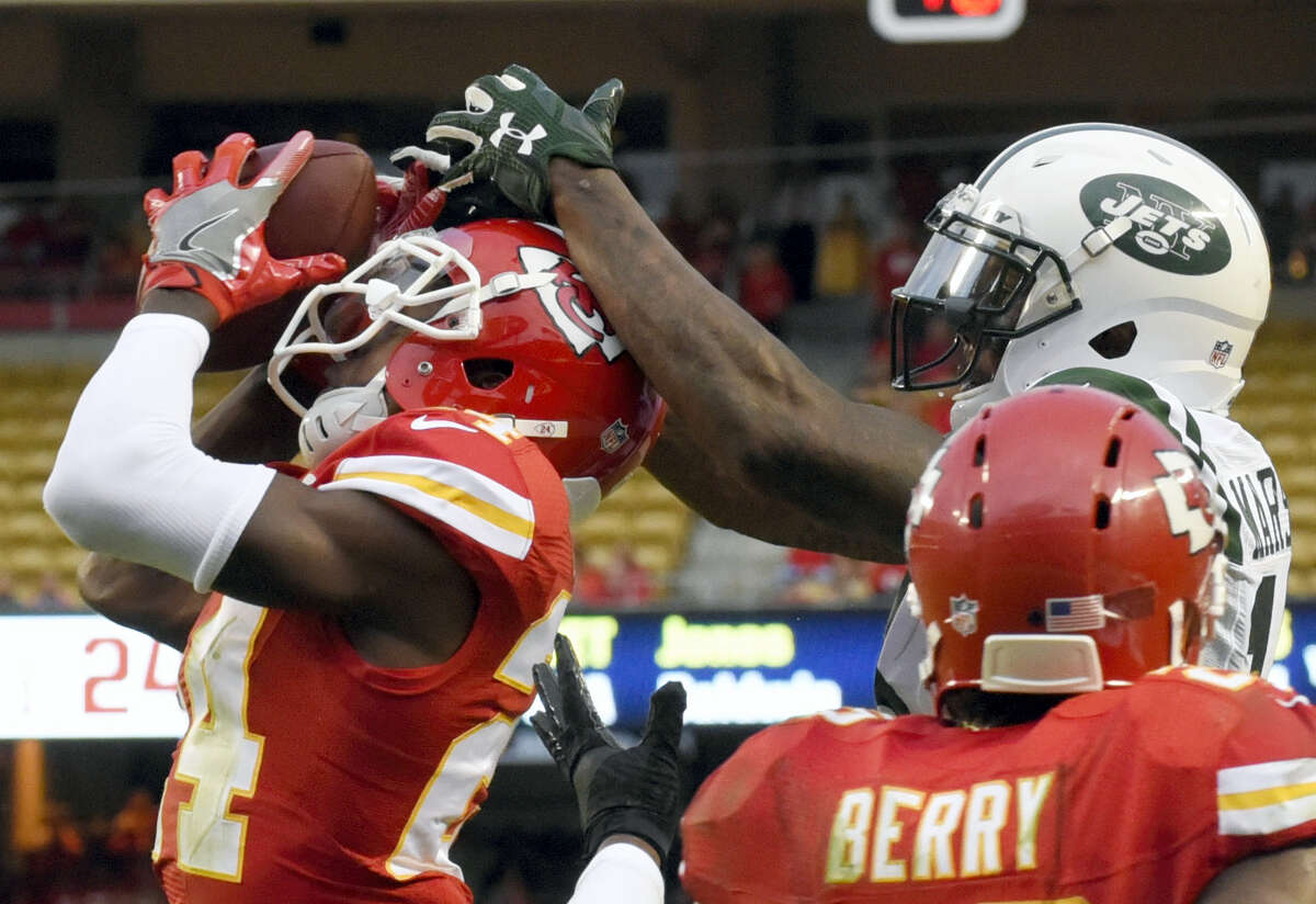 Chiefs defensive back D.J. White, left, intercepts a throw to Jets wide receiver Brandon Marshall during the second half Sunday.