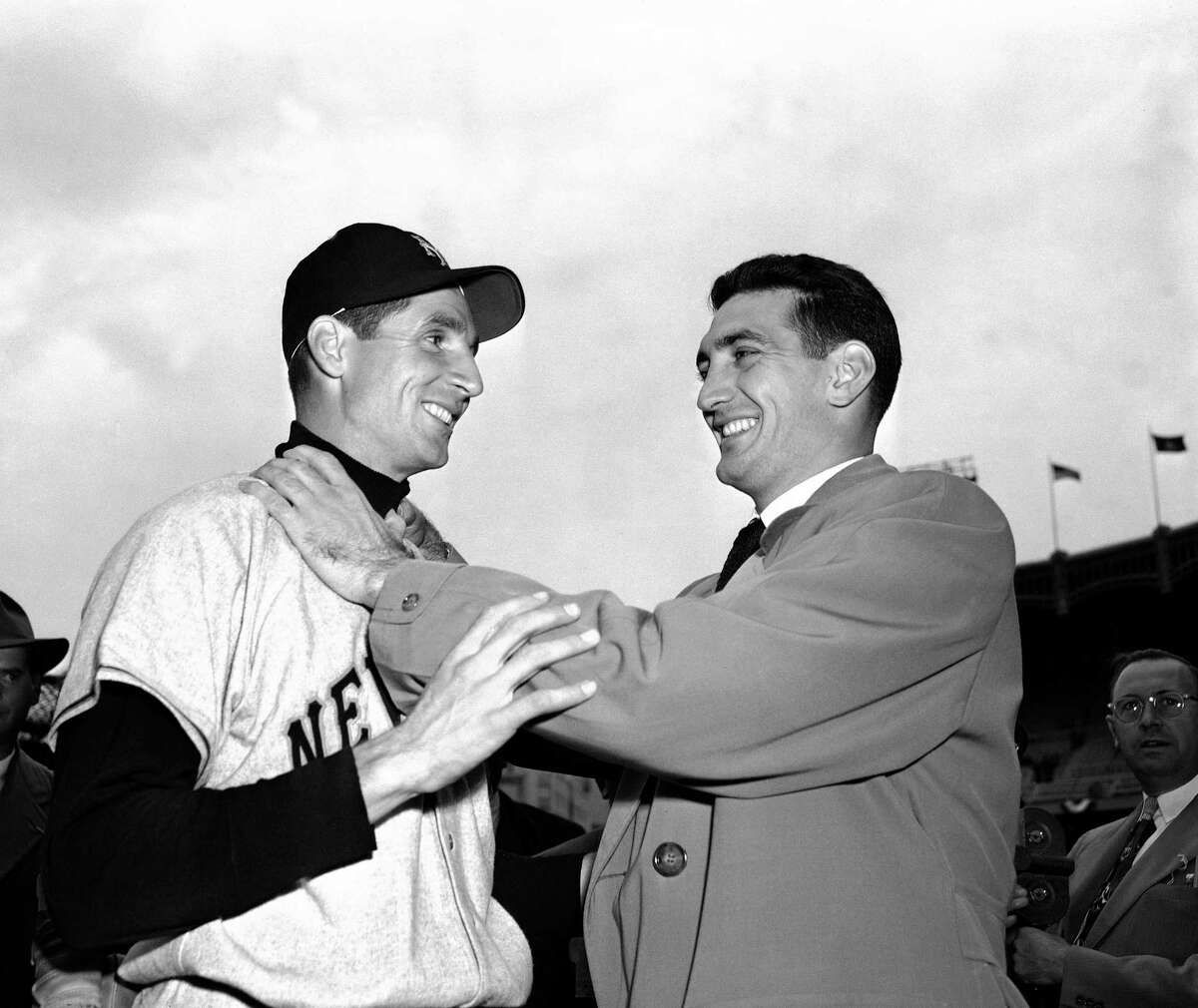 In this file photo, Bobby Thomson, left, of the New York Giants, and Ralph Branca of the Brooklyn Dodgers, engage in horse play before a World Series game at Yankee Stadium in New York. Branca, the Brooklyn Dodgers pitcher who gave up the home run dubbed the “Shot Heard ‘Round the World,” has died at the age of 90. His son-in-law Bobby Valentine, a former major league manager, says Branca died Wednesday at a nursing home in Rye, New York.