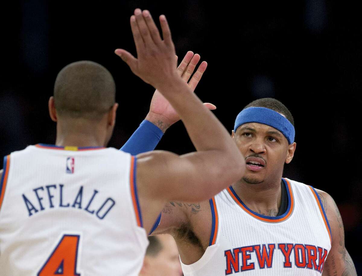 New York Knicks forward Carmelo Anthony, right, congratulates guard Arron Afflalo (4) after Afflalo hit a 3-point shot against the Utah Jazz late in the fourth quarter of an NBA basketball game, Wednesday, Jan. 20, 2016, in New York. The Knicks won 118-111 in overtime. (AP Photo/Julie Jacobson)