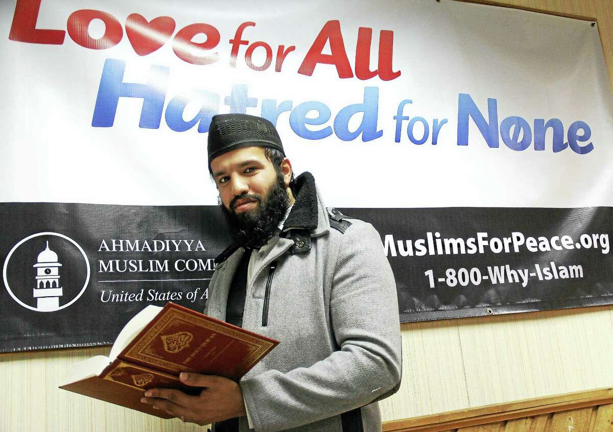 Middletown resident Miyan Zahir Muhammad Manna, mosque outreach director, holds the Holy Quran at the Baitul Aman “House of Peace” mosque, based in Meriden, for the statewide chapter of the Ahmadiyya Muslim Community.