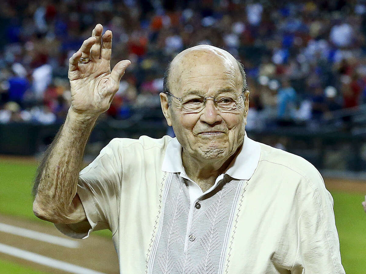 FILE - In this April 14, 2013, file photo, Arizona Diamondbacks broadcaster Joe Garagiola, center, waves to a cheering crowd during festivities honoring the retiring broadcaster, prior to a baseball game against the Los Angeles Dodgers, in Phoenix. Former big league catcher and popular broadcaster Joe Garagiola has died. He was 90. The Arizona Diamondbacks say Garagiola died Wednesday, March 23, 2016. He had been in ill health in recent years. (AP Photo/Ross D. Franklin, File)