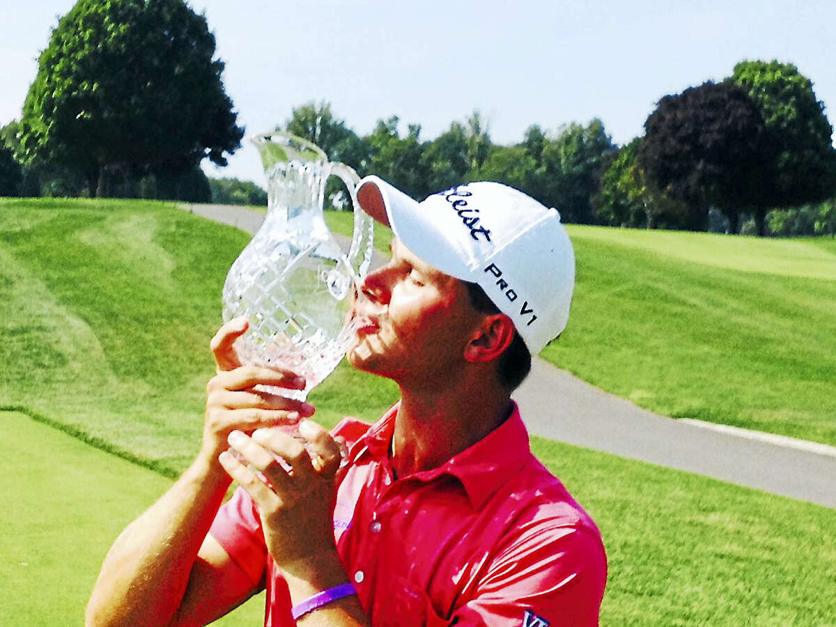 Cody Paladino kisses the championship trophy from last year’s Connecticut Open.