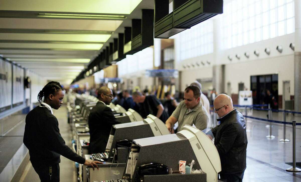 In this March 10, 2016, file photo, passengers check-in at the North terminal of the domestic passenger terminal at Hartsfield-Jackson Atlanta International Airport in Atlanta. Officials at Hartsfield-Jackson Atlanta International Airport this month said they were moving toward allowing Uber and other ride-sharing services, a reversal of a ban on such services from curbside pickup.