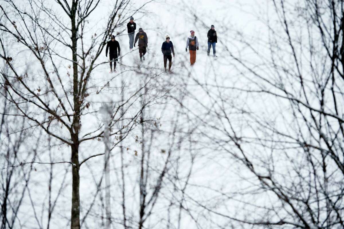 A group of friends enjoy the snow at a park in Knoxville, Tenn., on Wednesday, Jan. 20, 2016. As people in the South and East readied themselves for a nor’easter that might bring heavy snowfall by week’s end, snow fell on much of Kentucky and Tennessee and contributed to at least one traffic-related death Wednesday.