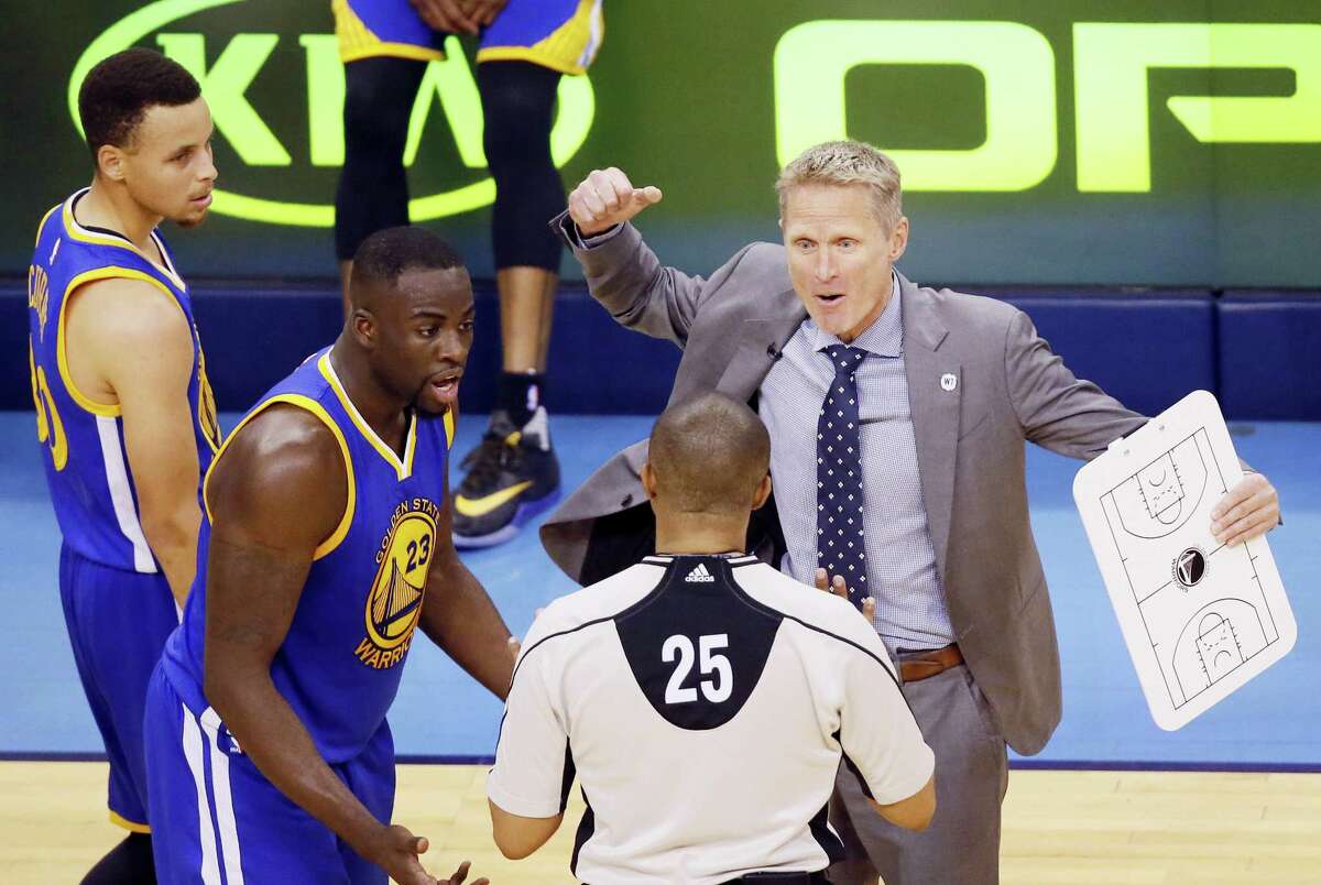 Warriors head coach Steve Kerr, right, and forward Draymond Green dispute a flagrant foul call on Green in the first half of Game 3 on Sunday.