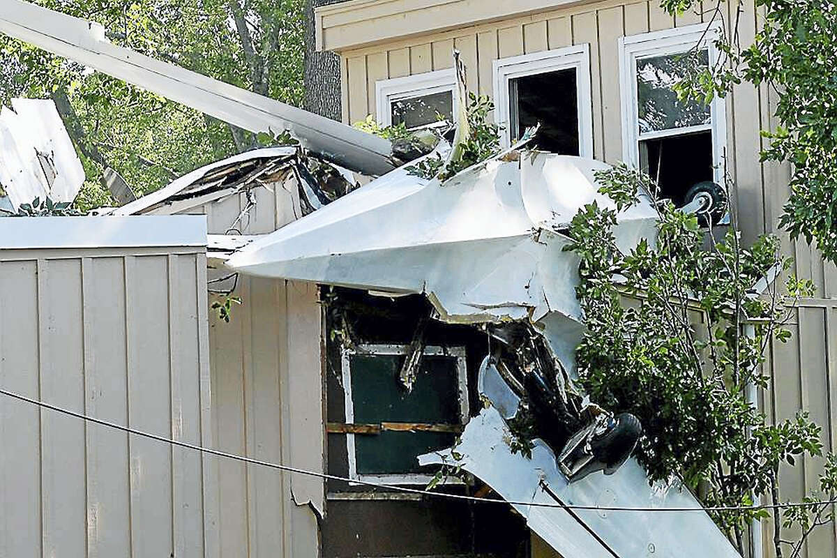 The pilot of a single-engine plane crashed his aircraft into a house on Little Meadow Road on Saturday in Haddam.