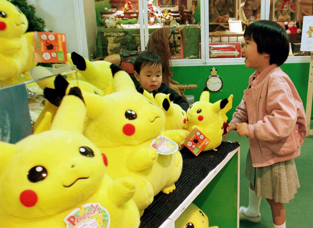 A girl and her brother view dolls of a Pokemon cartoon character at a toy shop in Tokyo’s Ginza shopping district. A survey shows about 90 percent of adults who have downloaded the new “Pokemon Go” smartphone game in 2016, which lets you find cartoon monsters in the real world, are between 18 and 34-years-old, many who are old enough to have fallen in love with Pokemon the first time around.