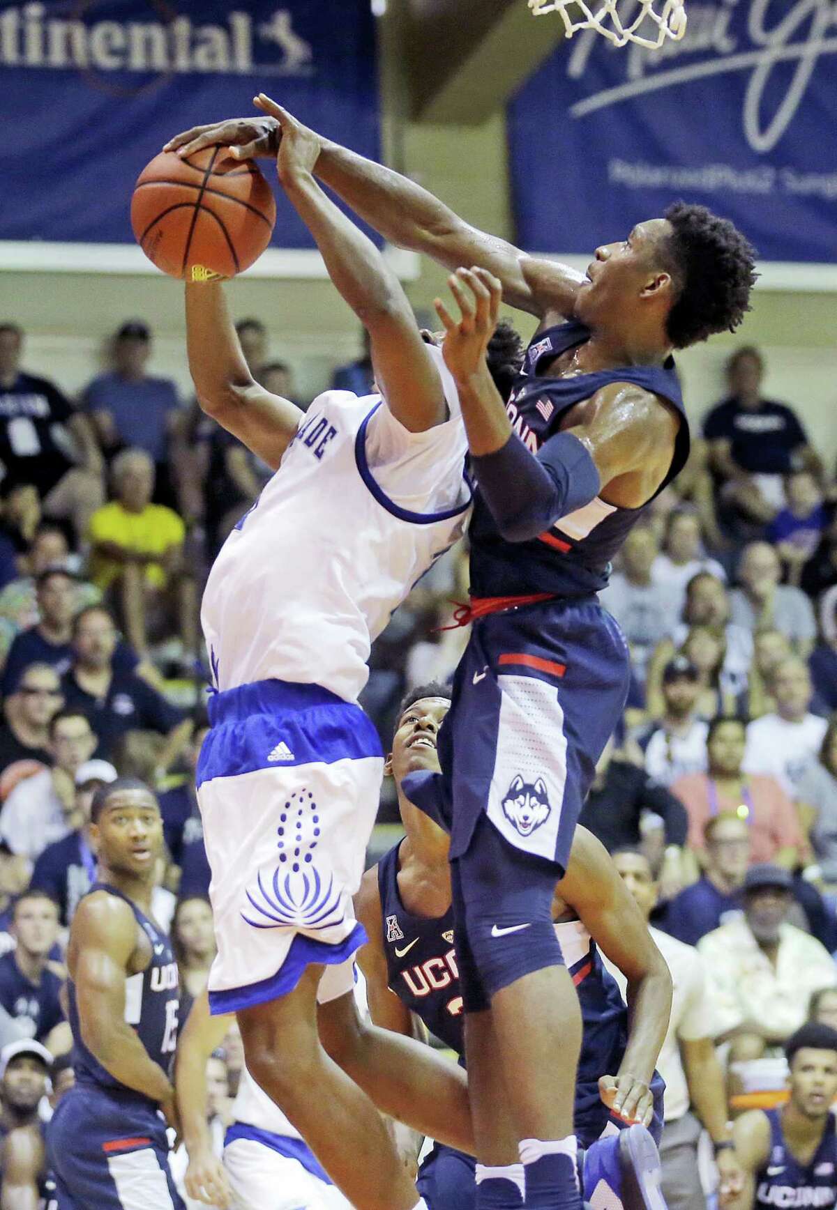 UConn guard Christian Vital, right, blocks the shot of Chaminade guard Rohndell Goodwin, left, in the first half during the Maui Invitational Tuesday.
