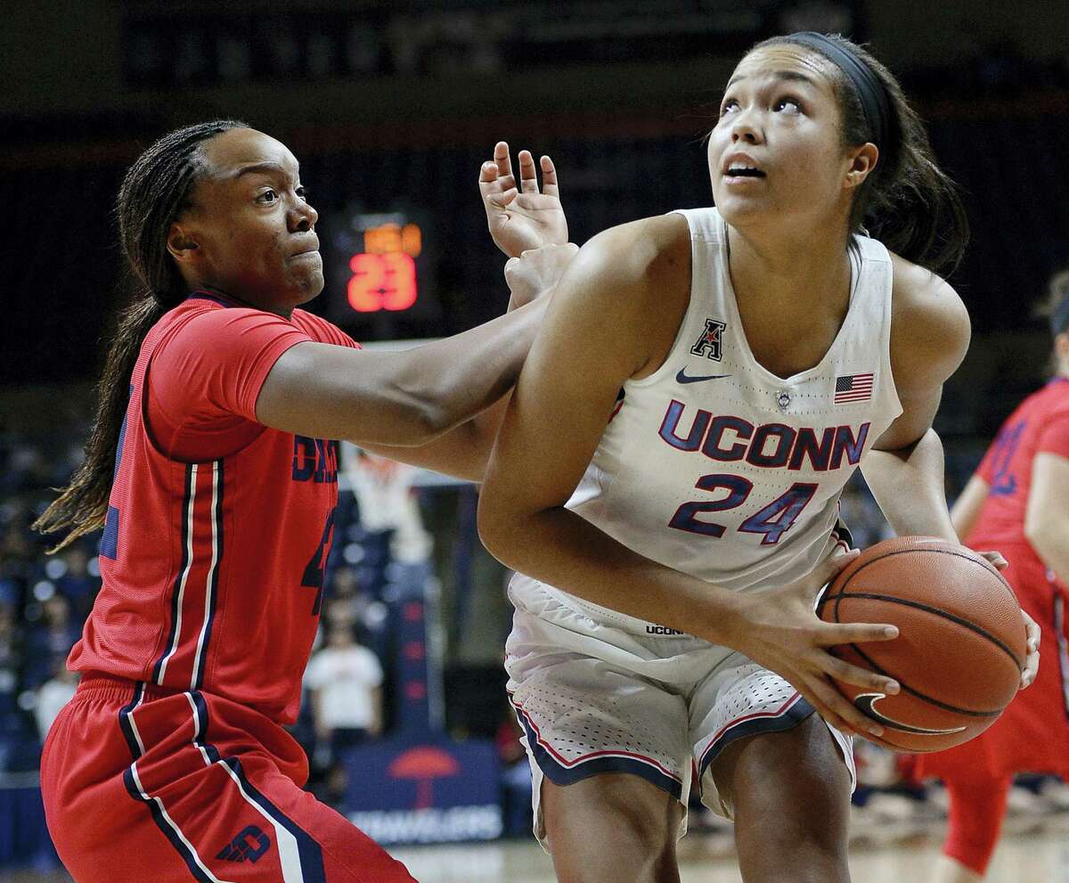 Dayton’s Jayla Scaife, left, guards UConn’s Napheesa Collier, right, in the second half at Gampel Pavilion. The Huskies beat Dayton 98-65.