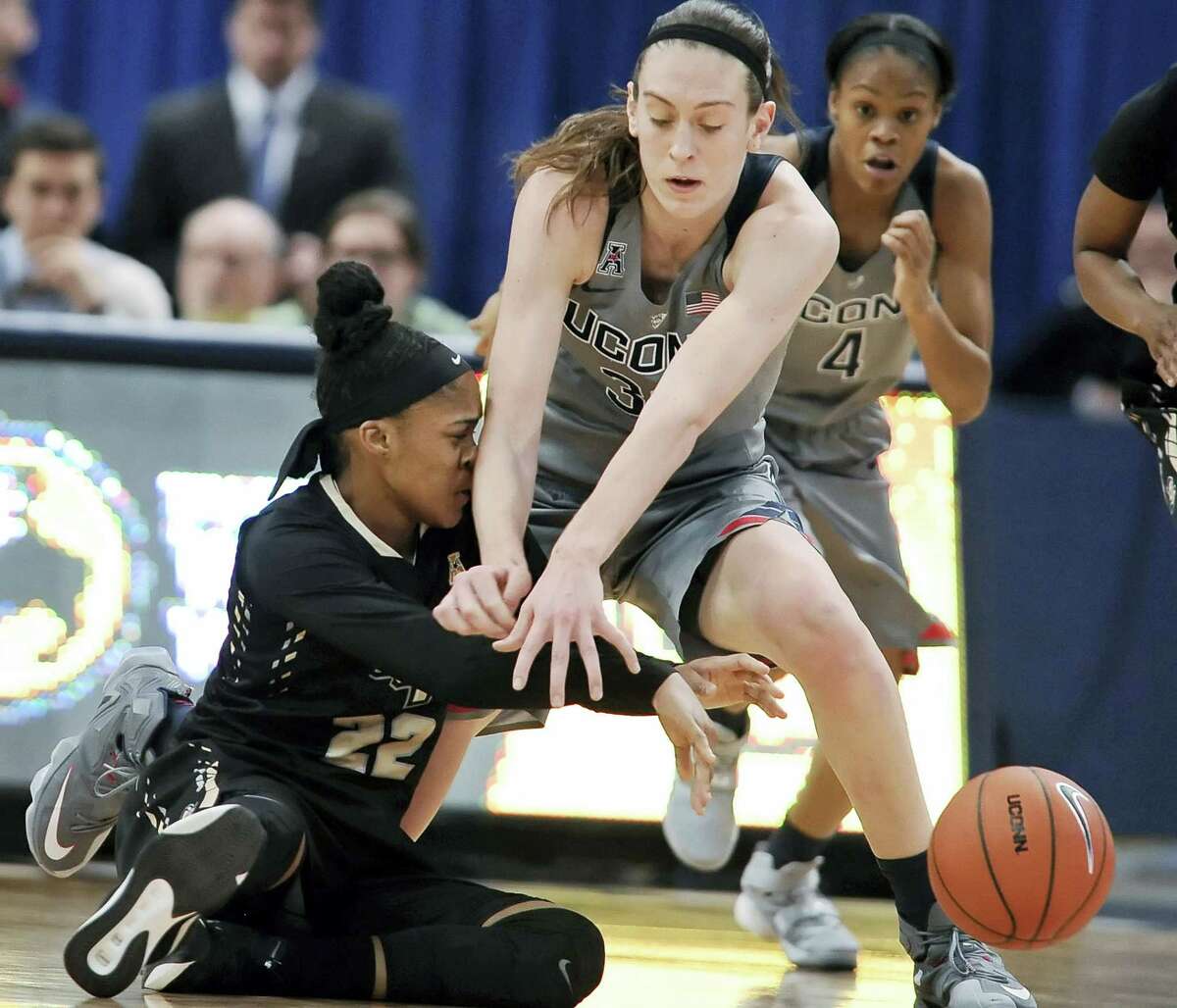 Connecticut’s Breanna Stewart, top, pressures UCF’s Aliyah Gregory during the first half.