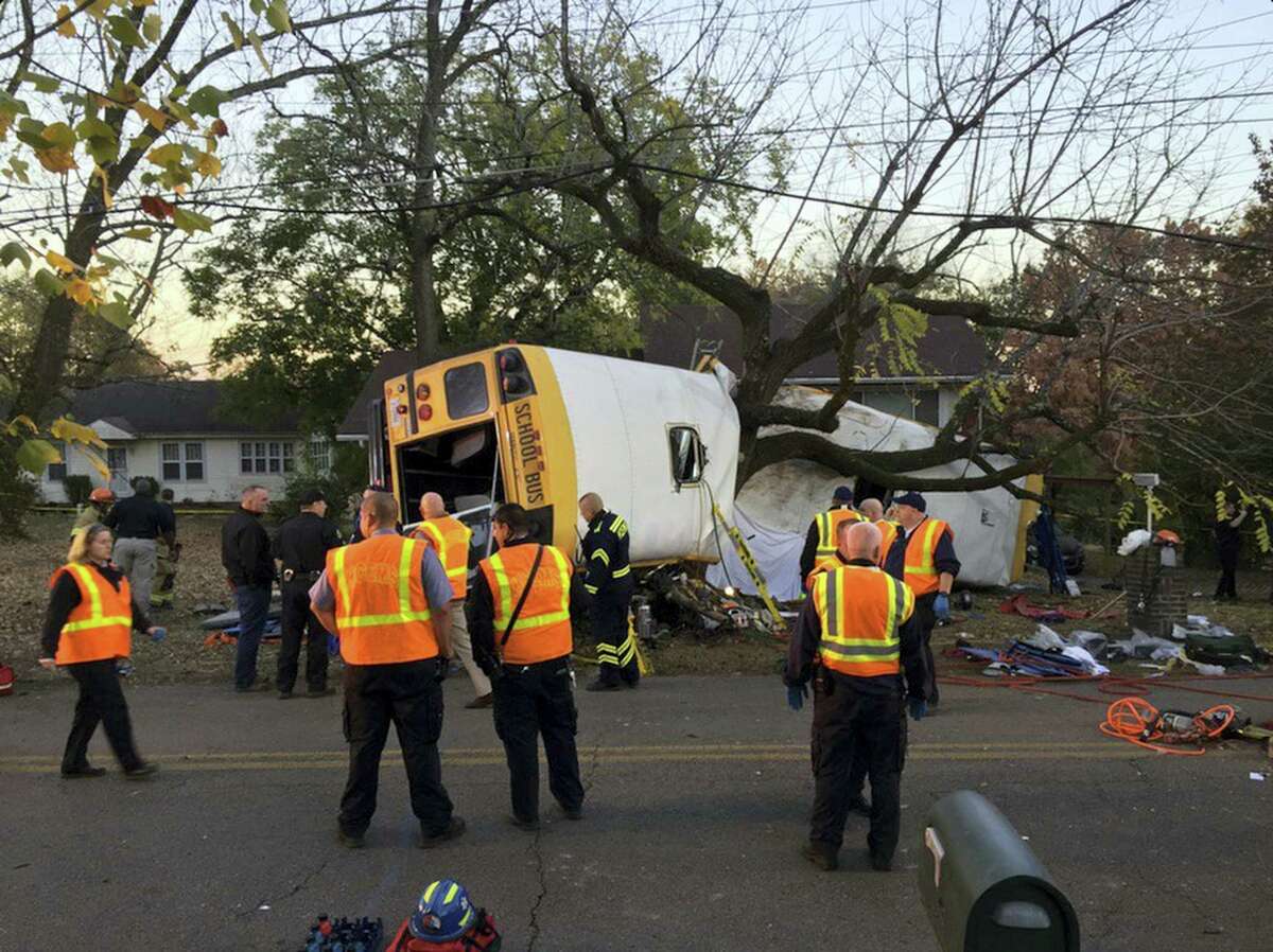 In this photo provided by the Chattanooga Fire Department via Chattanooga Times Free Press, Chattanooga Fire Department personnel work the scene of a fatal elementary school bus crash in Chattanooga, Tenn., Monday, Nov. 21, 2016. In a news conference Monday, Assistant Chief Tracy Arnold said there were multiple fatalities in the crash.