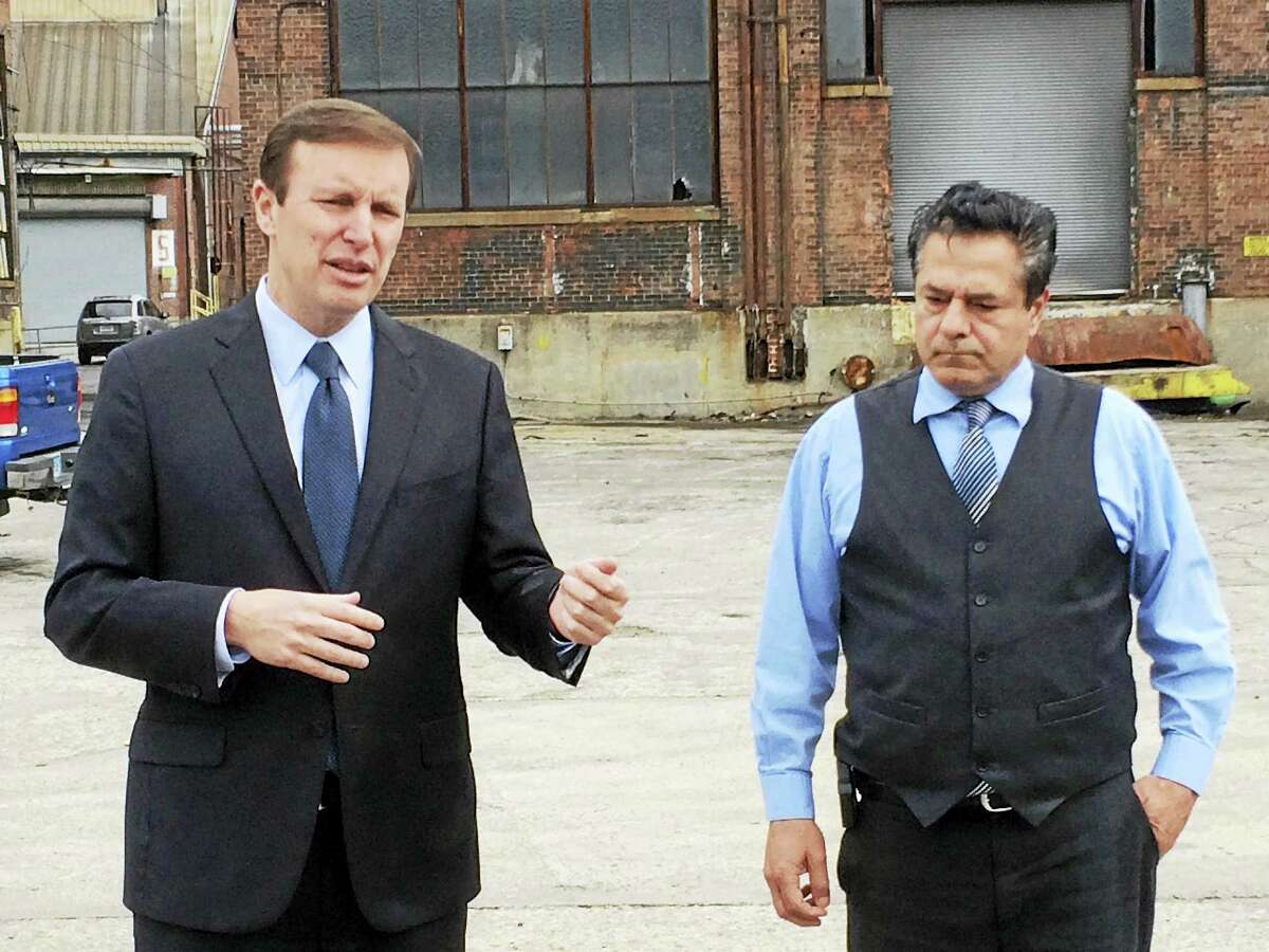 U.S. Sen. Chris Murphy, D-Conn., speaks to reporters Wednesday about cleaning up the former Ansonia Copper & Brass plant as Mayor David Cassetti looks on.