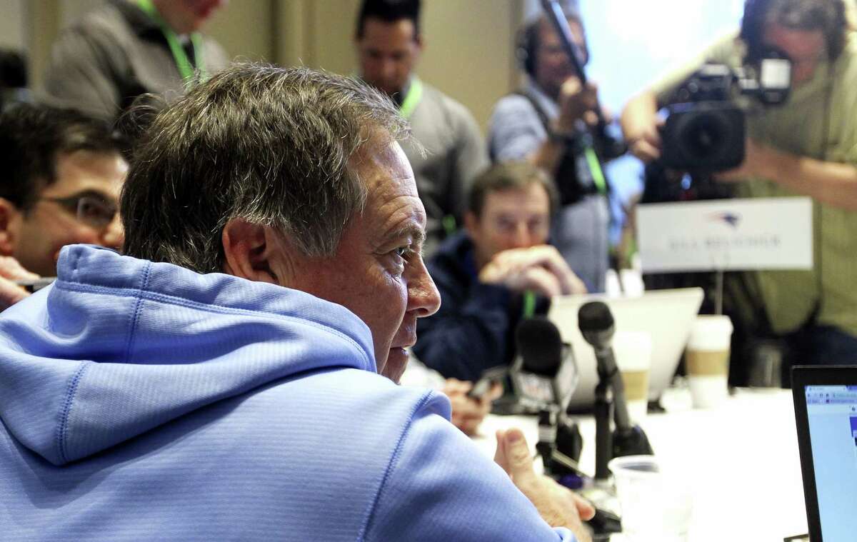 Patriots coach Bill Belichick, left, talks to a member of the media at the NFL owners meetings on Tuesday.