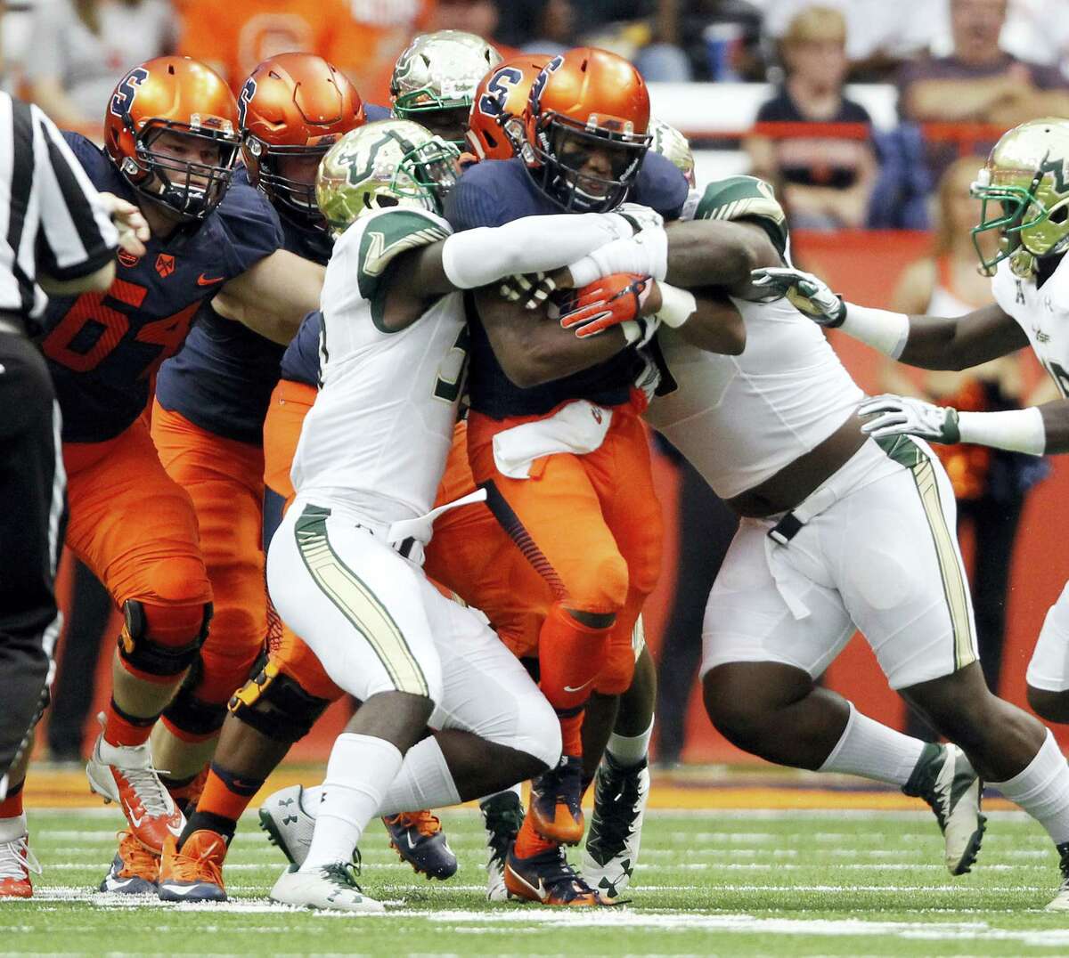 Syracuse’s Dontae Strickland, center, gets past the South Florida defense earlier this season.