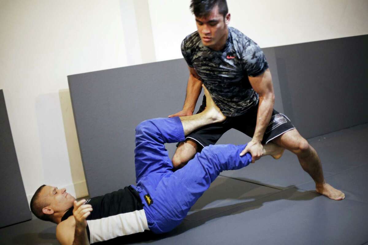 Rene Dreifuss, left, a mixed martial arts coach, trains Richard Callado at Radical MMA NYC, a New York gym, on Tuesday. New York is poised to end its ban on professional mixed martial arts, the last state to prohibit the combat sport.