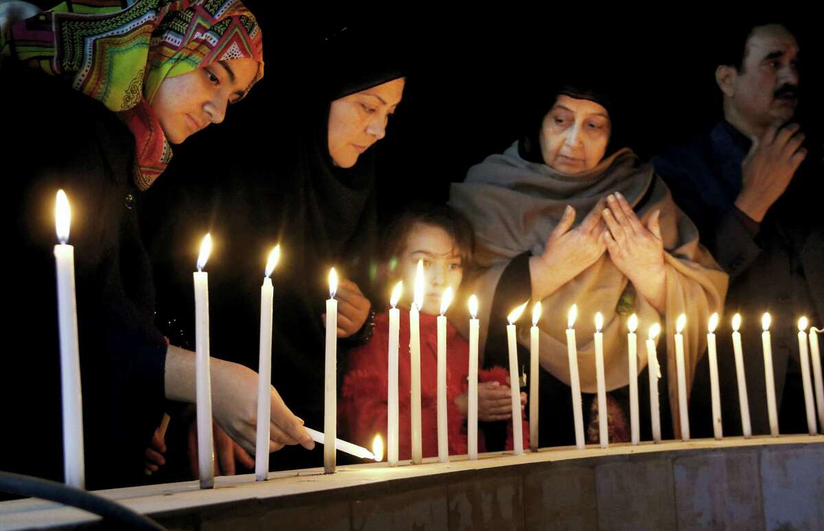 Pakistani women light candles during a vigil for victims of the Bacha Khan University attack, Wednesday, Jan. 20, 2016 in Peshawar, Pakistan. Taliban gunmen stormed a university in northwestern Pakistan on Wednesday, killing many people and triggering an hours-long gun battle with the army and police before the military declared that the assault in a town near the city of Peshawar was over.