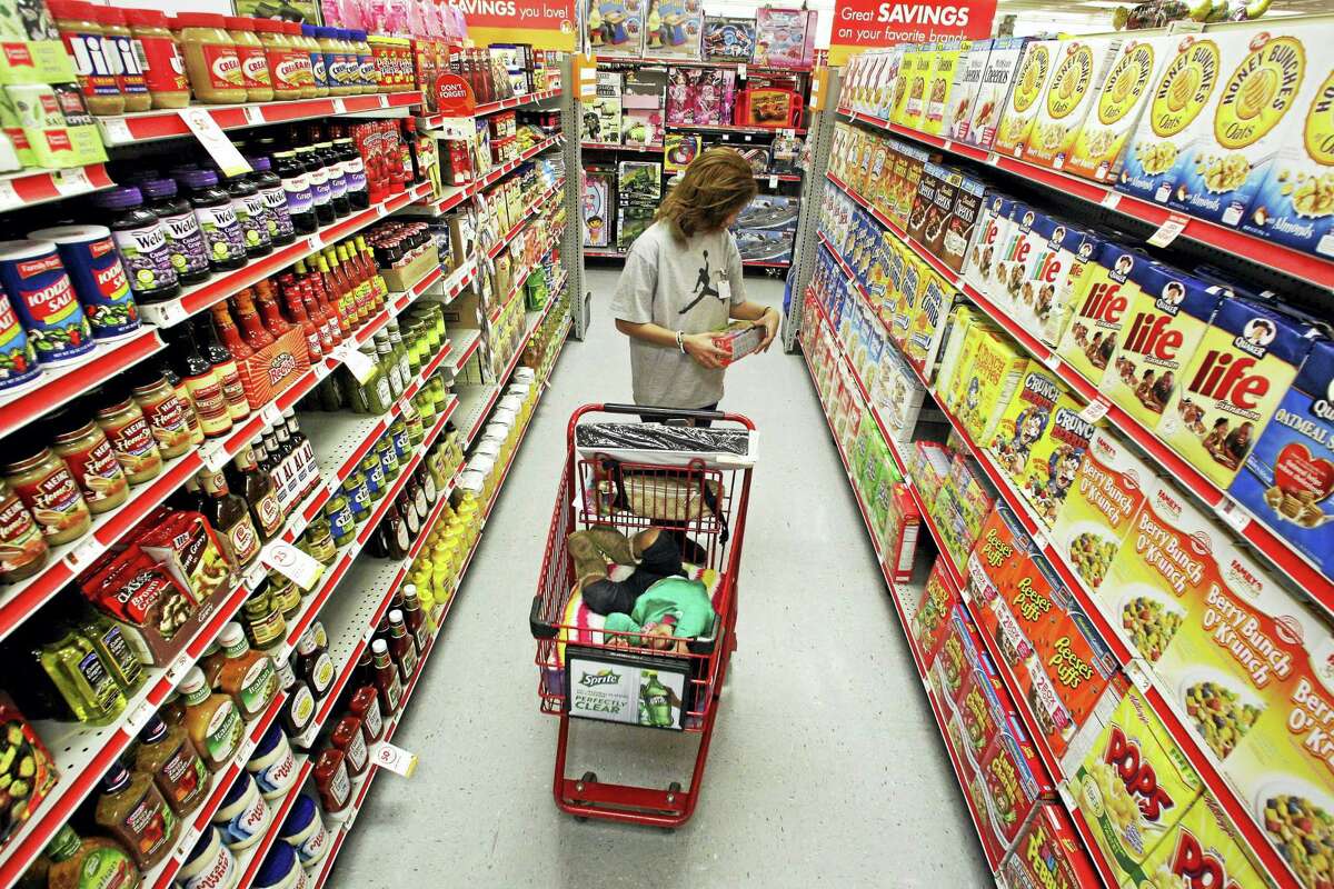 In this 2010 photo, Alicia Ortiz shops through the cereal aisle as her daughter Aaliyah Garcia catches a short nap in the shopping cart at a Family Dollar store in Waco, Texas.