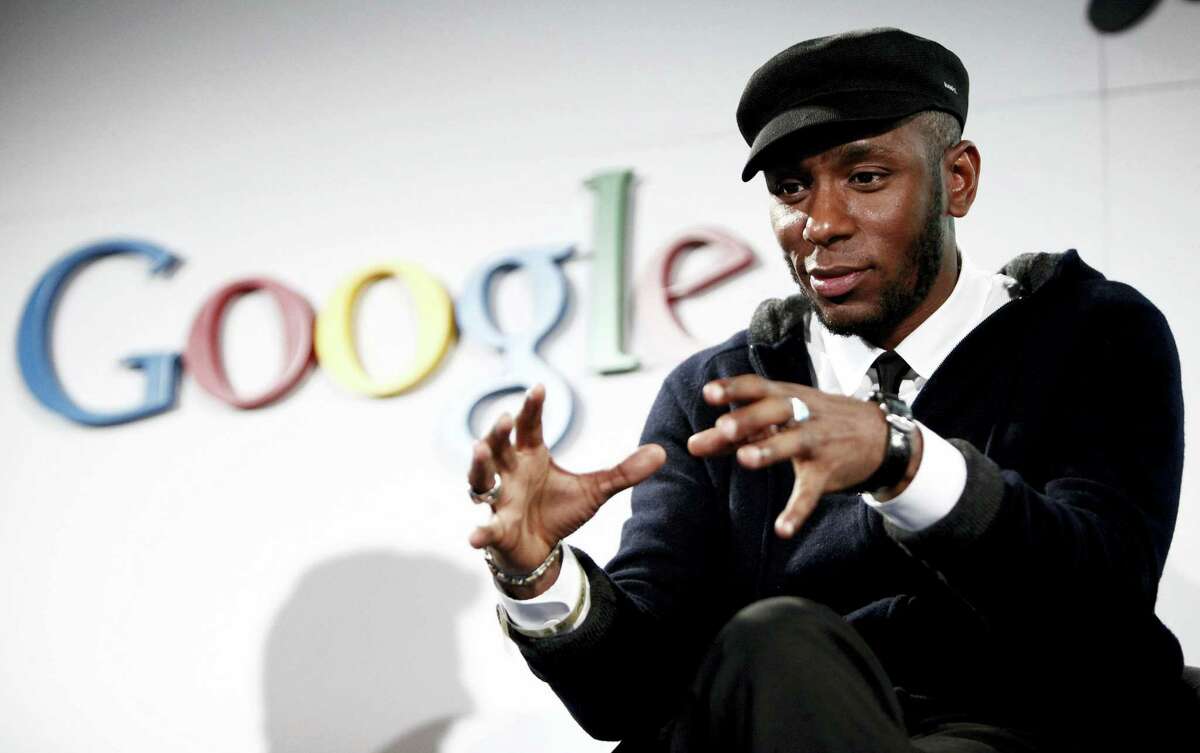 In this Oct. 28, 2009 photo, musician Mos Def speaks on a panel discussing Google’s new music search in Los Angeles. The American entertainer has been charged with using a false identity, using an unrecognized travel document and helping his family stay in the country illegally, a Home Affairs official said on Jan. 20, 2016.
