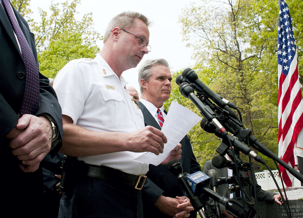 Auburn Police Chief Andrew Sluckis reads a statement about Auburn police Officer Ronald Tarentino who was fatally shot during a traffic stop in Auburn, Mass., Sunday, May 22, 2016. Worcester County District Attorney Joseph D. Early, Jr., right, joins Sluckis at the briefing.