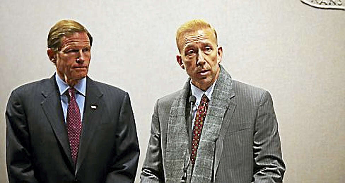 U.S. Sen. Richard Blumenthal, left, stands next to Craig DiAngelo, a former IT worker for Eversource.