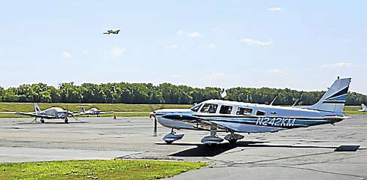 A plane moves on the tarmac Thursday morning as another flight departs Brainard Airport in Hartford.